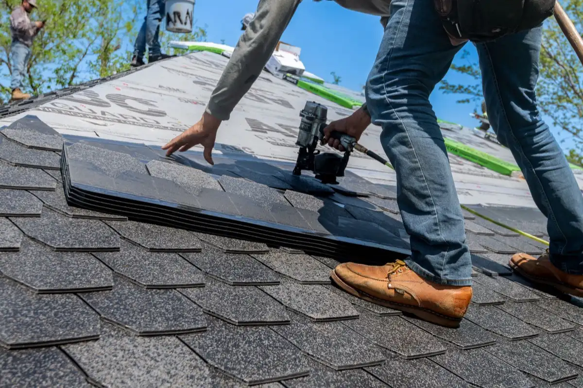 Inspecting an asphalt shingle slope after a hailstorm in Manchester, NH